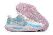 White basketball shoe with pale blue and pink panels and a pink outsole.