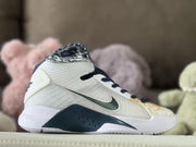 Side profile showing the dark Swoosh, white upper, and navy midsole accent.