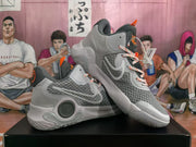 Pair of grey Nike KD basketball sneakers shown from a side and three-quarter angle on a black box.