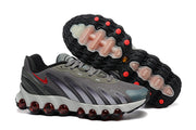 Gray Nike Air Max DN sneakers shown from the side and outsole, with red outsole details.