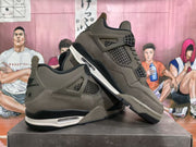 Angled view of the brown sneaker pair showing the side panels, black accents, white midsole sections, and textured outsoles.