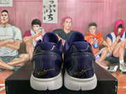 Rear view of the navy and purple basketball sneakers showing the white midsoles and signature-style heel markings.