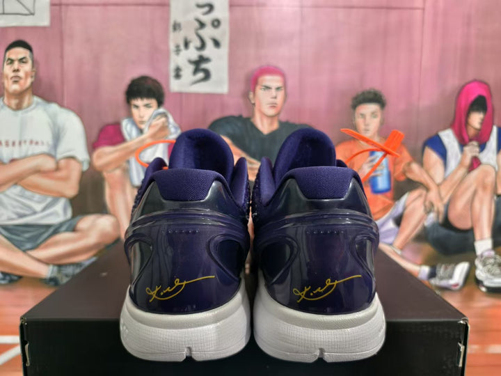 Rear view of the navy and purple basketball sneakers showing the white midsoles and signature-style heel markings.