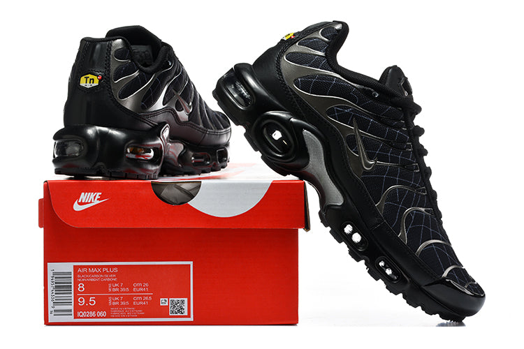 Black grid-pattern Nike Air Max Plus sneakers displayed with a shoe box
