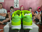 Rear view of fluorescent green Nike sneakers showing padded collars, white midsoles, green outsoles, and signature-style heel details.