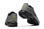 Rear and outsole views showing the heel badges and black tread.
