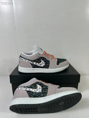 Angled product view highlighting the patterned upper, pink laces, white midsole, and black outsole.
