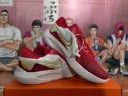 Angled view of the pair highlighting the gold side detailing, red uppers, white midsoles, and textured outsoles.