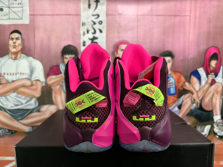 Rear view of maroon Nike high-top basketball sneakers with bright pink collars, neon green details, and translucent soles.
