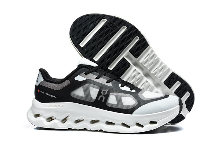 Black and white On Cloudtilt Remix sneakers, showing the side profile and outsole.