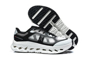 Black and white On Cloudtilt Remix sneakers, showing the side profile and outsole.