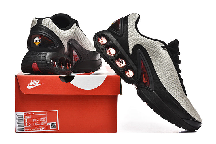 Nike Air Max DN sneakers beside a box; the box label shows size US Men 8 and a product code.