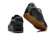 Rear and outsole views of black and grey Nike Air Max 90 sneakers