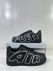 Two black low-top sneakers shown from side angles with large outlined AIR and FLEA lettering.