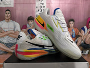 Angled view of paired white and gray Nike GT sneakers showing mesh-textured sides, colored midsole sections, and black swoosh branding.
