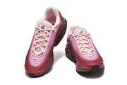 Top view of a pair of pink gradient Nike Air Max DN sneakers with pale pink laces.