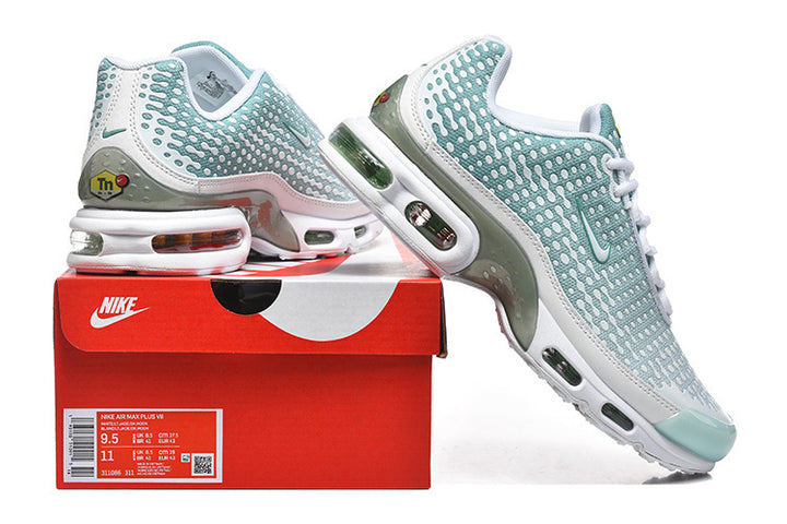 Teal and white Nike Air Max Plus VII sneakers displayed on a red shoe box; the box label is visible.