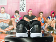 Rear view showing the textured black heels and white midsole sections of the sneakers.