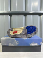 Outsole view showing the gray rubber tread, blue circular forefoot section, and cream center panel.