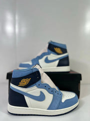 Close-up side view of the blue, white, and navy sneaker with ankle Wings motif