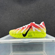 Side profile of a Nike sneaker showing the black Swoosh, textured multicolor upper, and neon yellow sole.