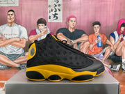 Side profile of a black and yellow high-top sneaker