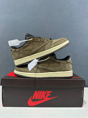 Two olive green sneakers arranged together on a shoebox.