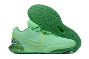 Mint green Nike basketball shoes with bright green patterned outsoles.