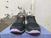 Front view of black lace-up Nike basketball shoes with lavender accents