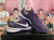 Two purple basketball shoes shown together with white logos and yellow accents
