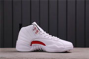 Side profile of a white Jordan 12 high-top sneaker with a red side-panel accent.