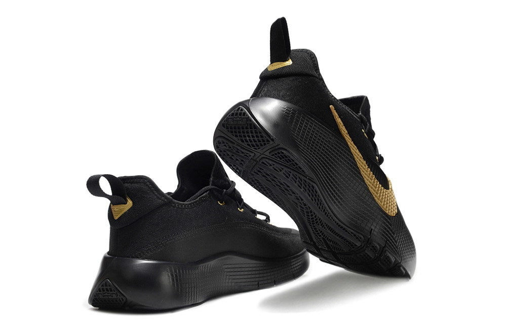 Black and gold James TR1 sneakers shown from the side and outsole.