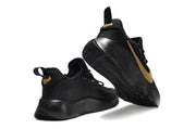 Black and gold James TR1 sneakers shown from the side and outsole.