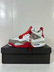 Single side profile of the white, gray, and red Jordan Dub Zero sneaker on a black box.