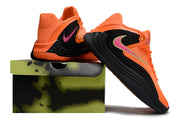 Orange and black Nike Giannis Immortality 7 shoes beside a display box