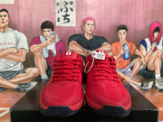 Front view of red Nike basketball sneakers with red laces, white tongue branding, and dark toe outsoles.