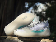 Pair of Jordan 39 sneakers shown from above and the side, highlighting the translucent outsole.