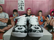 Front view of the matching sneakers showing the patterned toe boxes, white laces, and red-and-black details.