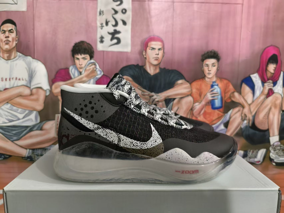 Side view of a black and white Nike Zoom basketball sneaker with patterned laces, speckled midsole, and translucent outsole.