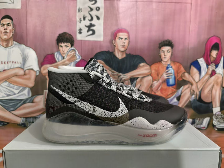 Side view of a black and white Nike Zoom basketball sneaker with patterned laces, speckled midsole, and translucent outsole.