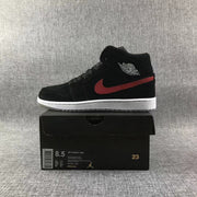 Side profile of the sneaker displayed on a box labeled Air Jordan 1 Mid, showing size US 8.5, EU 42, CM 26.5, and style code 554724-065.