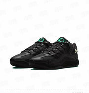 Pair of predominantly black Nike KD 18 basketball sneakers shown at a three-quarter angle, with green tongue branding and light-colored heel Swooshes.