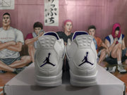 Rear view of white high-top sneakers with purple Jordan branding on a box