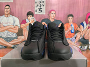 Front view of black and purple Jordan basketball sneakers with black laces and visible Jordan tongue branding.