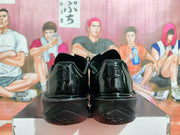 Rear view of a pair of black Nike GT Cut 3 basketball shoes showing the heel details.