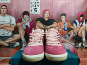 Front view of pink and burgundy low-top adidas sneakers with light laces