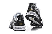 Rear and outsole views of white and black Nike sneakers.