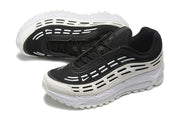 Pair of black and off-white sneakers shown from above and at an angle