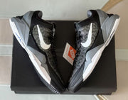 Top-down view of the sneaker pair arranged on a black shoebox.