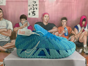 Side view of blue Nike basketball sneakers showing the Swoosh and sculpted outsole.